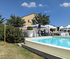 Outdoor pool with white gazebos and tables set for a summer event at an elegant location
